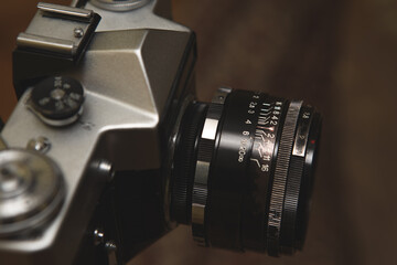 Selective focus on the lens of an old analog camera. The camera is very old and ruined, traces of...