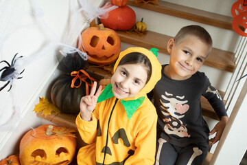 Fototapeta premium Cheerful siblings ready for halloween trick or treat