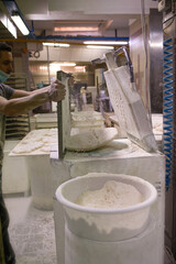 Baker makes buns with industrial press