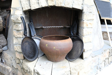 Old cast iron cookware in stone oven - Powered by Adobe