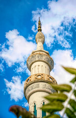 Minaret of an ancient mosque against a blue sky	