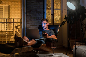 Male freelancer working in evening at home