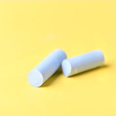 Soft pastels on yellow background. Close up. Copy space.