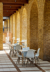 Fototapeta na wymiar empty tables in a loft-style cafe with brick columns