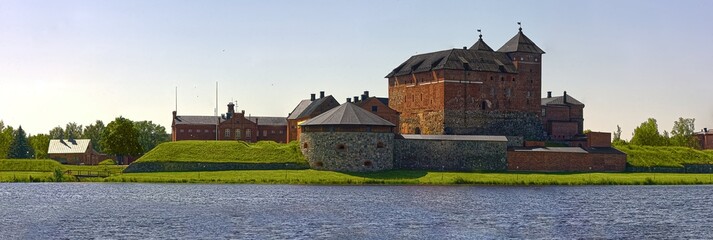 Huge size panorama photo of a castle of Häme in Finland. Summer lake vanaja overview in Hämeenlinna city in northern europe. Medieval tourist sight theme. Historical location. 