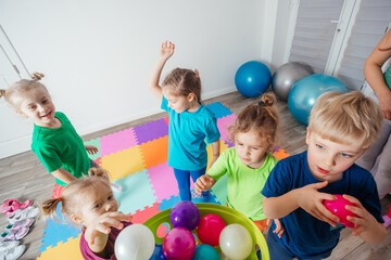 Fototapeta na wymiar Sporty kids enjoying activities with young teacher