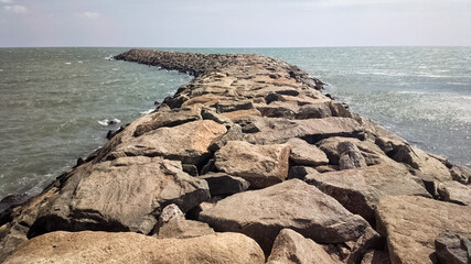 A rocky pier jutting into the Indian Ocean in the town of Kanyakumari in Tamil Nadu, India.