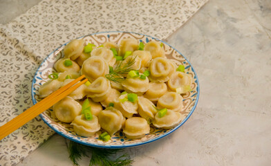 dumplings, sticks on concrete background

