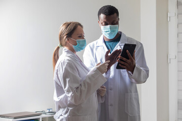 Fototapeta premium Diverse male and female doctors in white medical masks