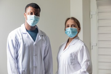 Fototapeta na wymiar Diverse male and female doctors in white medical masks