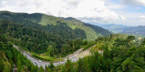Curve road up to the Genting Highlands Malaysia with green tree and sky at Bentong Pahang.