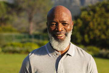 Portrait of smiling senior african american man in stunning countryside