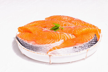 Fresh raw salmon or trout fish fillet steaks. Minimalistic design, modern hard light, dark shadow