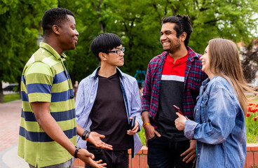 Outdoor communication between joyful multiracial college students