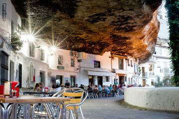 Tourist enjoying good food and drinks in the restaurants of Setenil de las Bodegas, Spain - obrazy, fototapety, plakaty