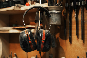 protective ear muffs. a creative working workshop of a wood sculptor.