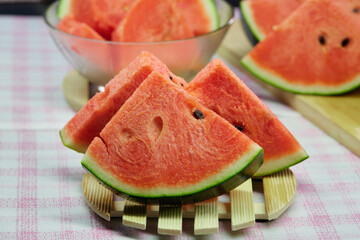 slices of watermelon on wooden plate