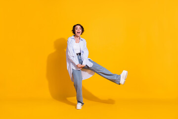 Fototapeta na wymiar Full length body size photo of funny girl playing careless fooling stylish outfit isolated on bright yellow color background