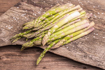 Ripe asparagus ready for cooking on vintage wooden stands