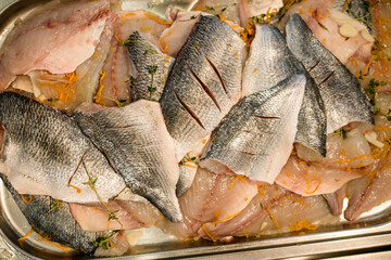 Cut raw fish fillet with spices. Preparation for cooking. Close-up top view