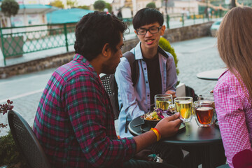 Multiracial group of friends having lunch together