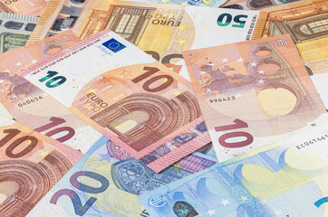 Obraz premium Bunch of euro banknotes. Many Euro bills lie on top of each other. Pile of money of the European Union. Currency of the united Europe. Cash balance of the European Central Bank or ECB. Portraits align