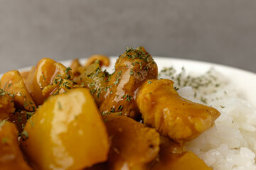 Curry with vegetables and meat eaten with rice