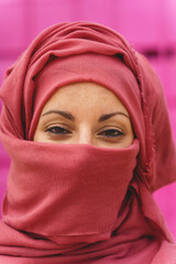 Vertical portrait of muslim woman wearing hiyab with eyes opened. Cultural diversity and religion.