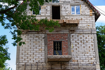 Fototapeta na wymiar Construction of a small brick house in nature.