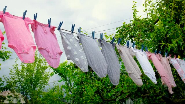 Baby clothes are dried outside. Selective focus.