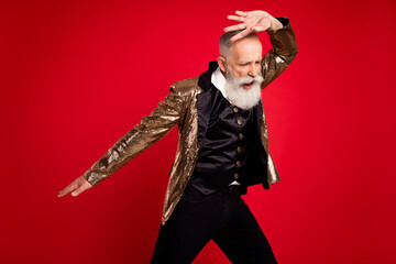 Photo of cool grey beard elder dancer man wear gold suit isolated on red color background