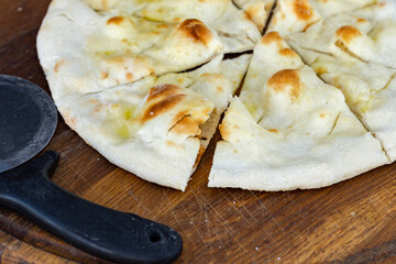 Italian original pizza dough. Baked pizza dough with cutting tools.