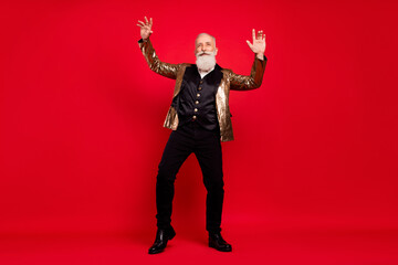 Fototapeta premium Full length body size view of attractive cheerful grey-haired man dancing having fun isolated over bright red color background