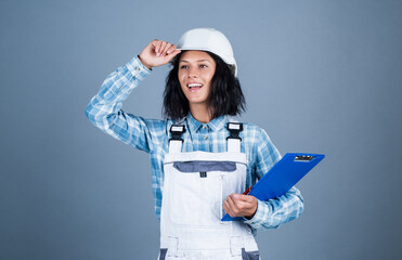 Create your dream home. mechanic girl in hardhat. building and construction. professional manual worker. technician working folder planning documents. safety uniform