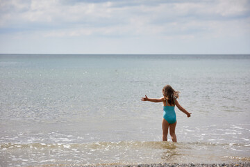 Fototapeta premium summer scene of a Caucasian girl on the beach. Summer and vacation concept