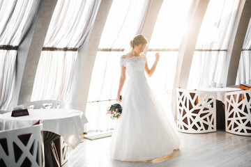 Naklejka premium Bride holding big and beautiful wedding bouquet with flowers
