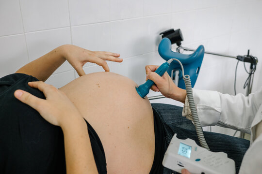 Medical research. Doctor gives the patient a female abdominal ultrasound. Ultrasound scanner in the hands of a doctor.