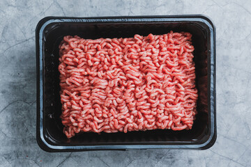 Minced meat with spices on table
