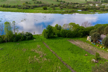 Bird's-eye view: river, fields, village.
