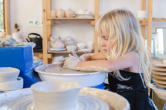 Little Kid Learning Pottery At Workshop