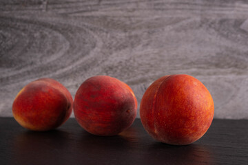 juicy peaches lie on a black background