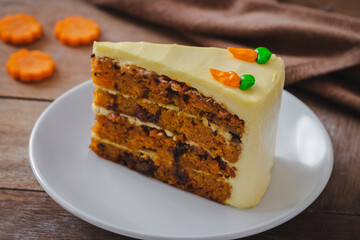 Slice of carrot cake on white plate