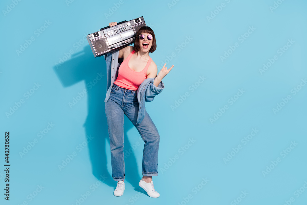 Canvas Prints Full length body size view of attractive cheerful girl carrying boombox showing horn isolated over bright blue color background