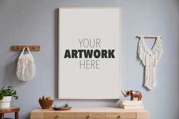 Stylish composition of creative hall/living room design with mock up poster frame,wooden commode, plants and boho accessories. Template. © FollowTheFlow
