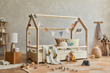 Creative composition of cozy scandinavian child's room interior with wooden furniture, plush and...