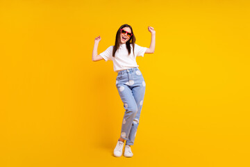 Fototapeta na wymiar Full body photo of young excited girl happy positive smile have fun enjoy music dance isolated over yellow color background
