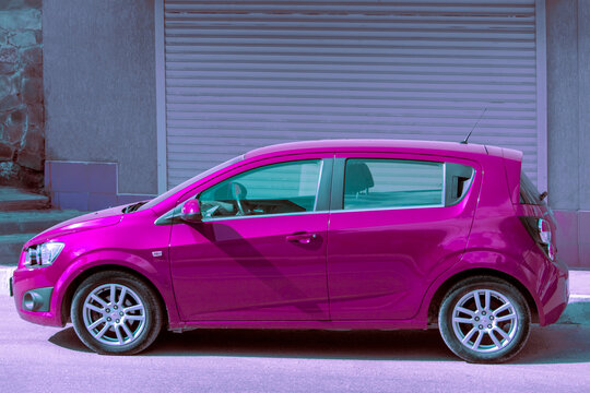 Purple Car Chevrolet Aveo hatchback. Sunny autumn day. Side view. Crimea, Sudak - 10 October 2020.