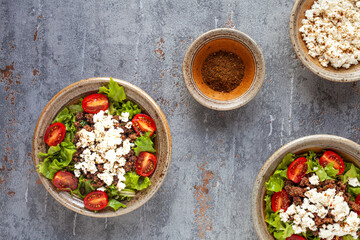 Fresh salad with whole grain teff, cheese and mitmita spice blend. Ethiopian cuisine.