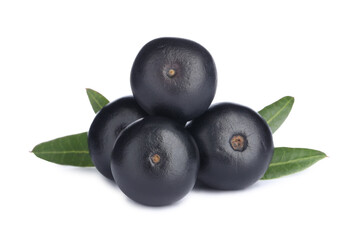 Pile of fresh ripe acai berries and green leaves on white background