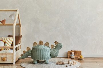 Stylish composition of cozy scandinavian child's room interior with wooden bed, rattan basket,...